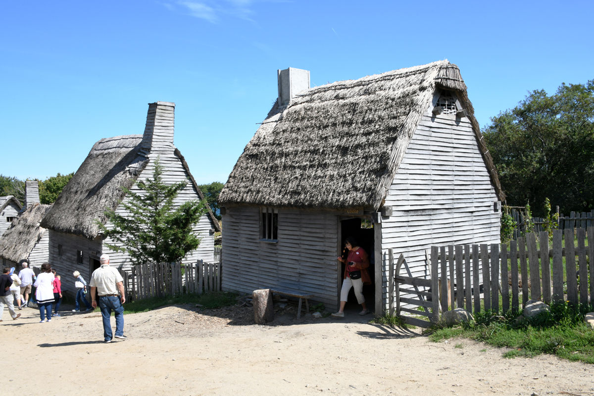 031 Mary Folkerts emerges from one of the 17th century homes which have been re-created at Plimoth Plantation.jpg